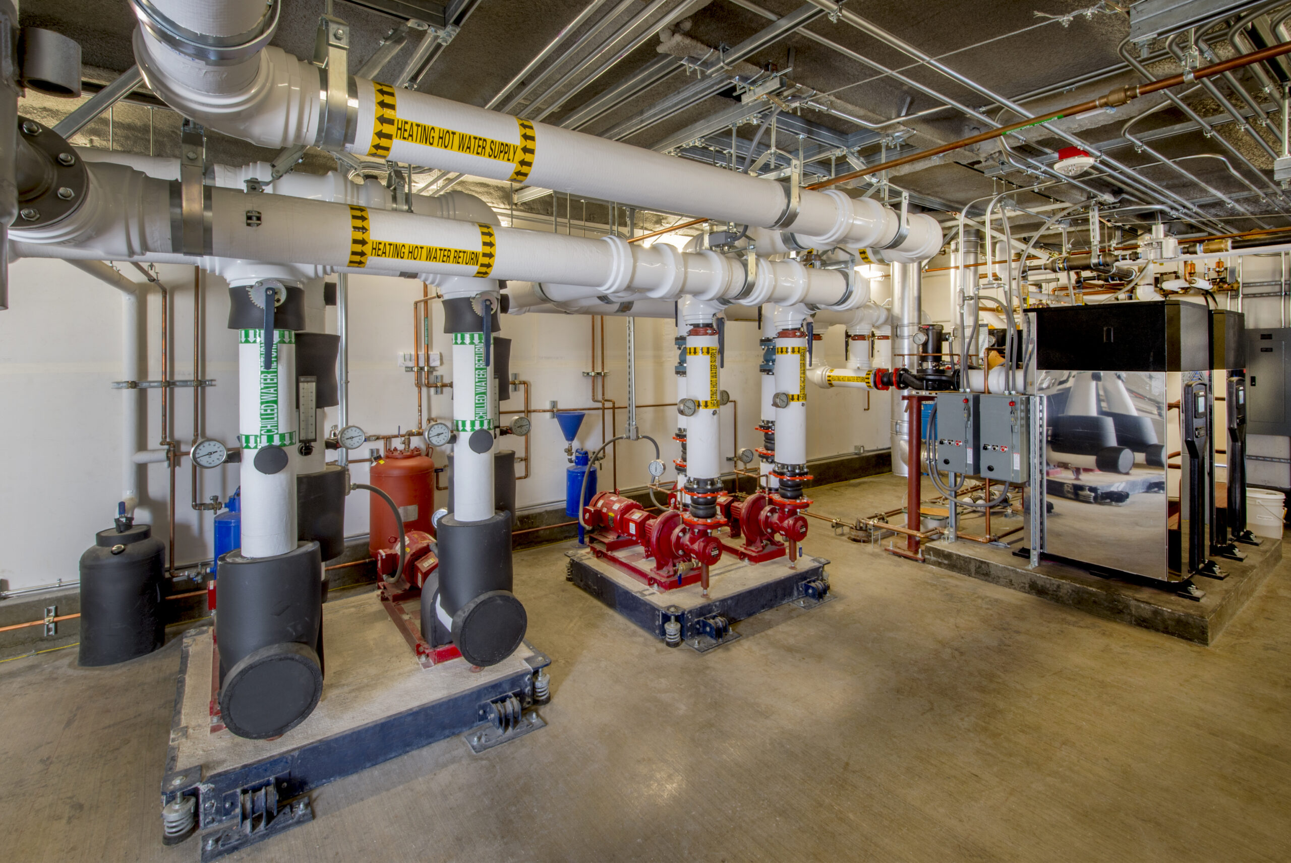 Boiler room with water circulating pumps and associated plumbing.